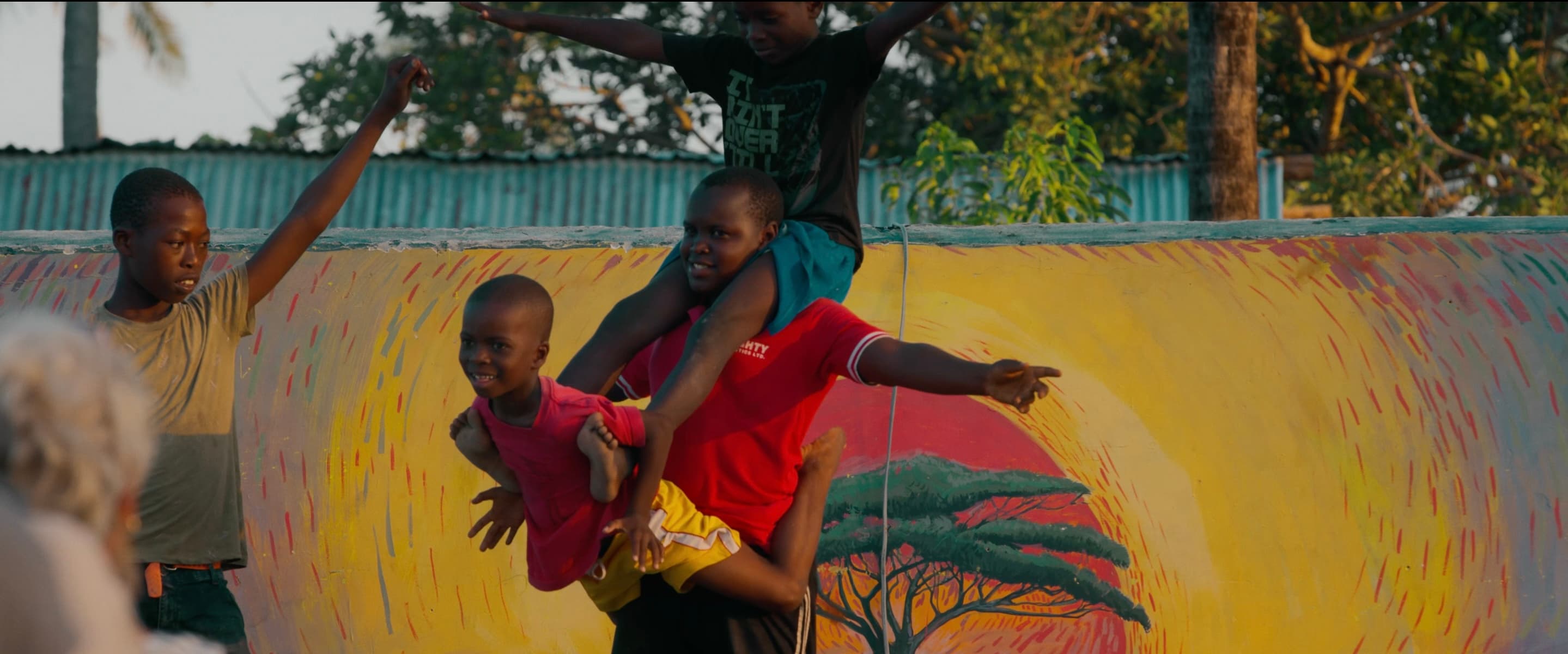 Children playing together on the painted mural wall at the Move Zanzibar Community Centre