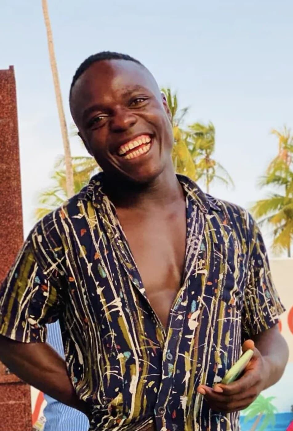 Ndimu, founder of Move Zanzibar, smiling on the beach in Zanzibar