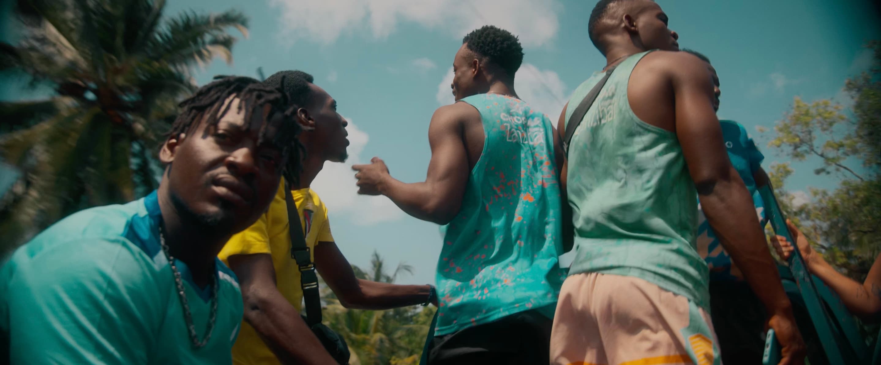 Move Zanzibar performers together, wearing the center's team shirts